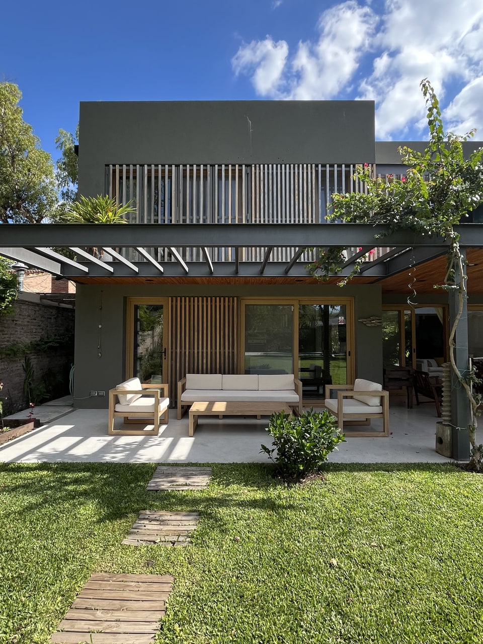 Casa con pérgola y conjunto de muebles de exterior con tapizado náutico — Velenza
