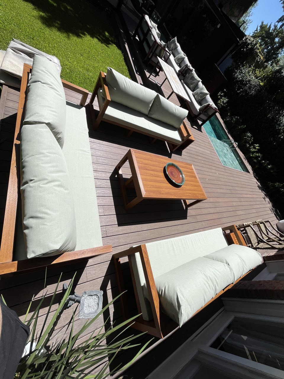 Conjunto de muebles de exterior con tapizado náutico claro sobre deck de madera — Velenza